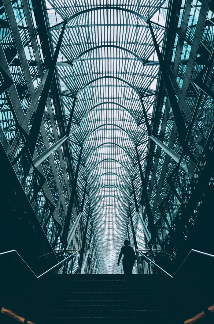 Dramatic view of a person silhouetted against modern architectural ceiling in Toronto.